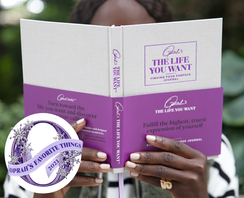 woman holding Oprah's The Life You Want Finding Your Purpose Journal