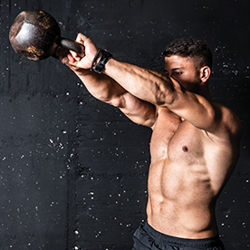 Man working out using a kettlebell